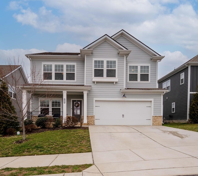 view of front of property with a front lawn, a porch, and a garage