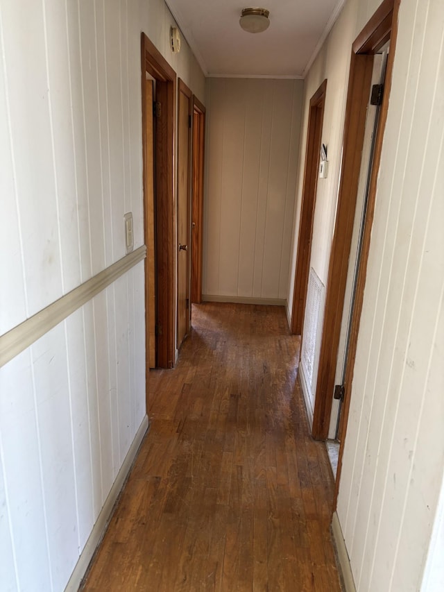 hallway featuring dark wood-style floors and crown molding