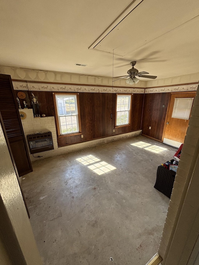 unfurnished living room with visible vents, unfinished concrete flooring, and heating unit