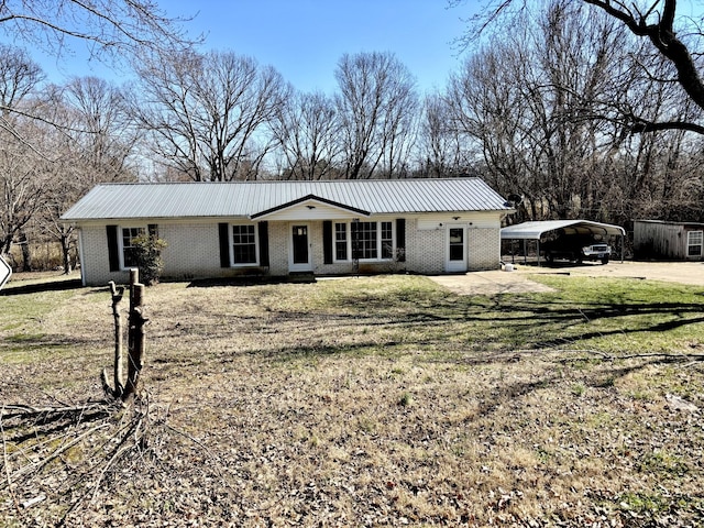 ranch-style house with metal roof, a carport, brick siding, and a front yard