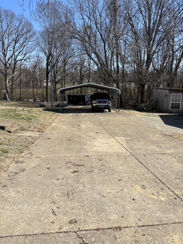 view of parking with a carport and driveway