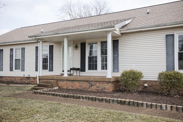 property entrance featuring crawl space, covered porch, and roof with shingles