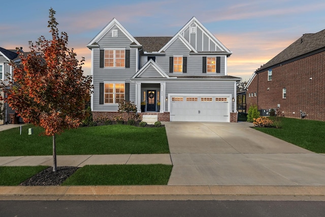 view of front of house featuring a garage and a lawn