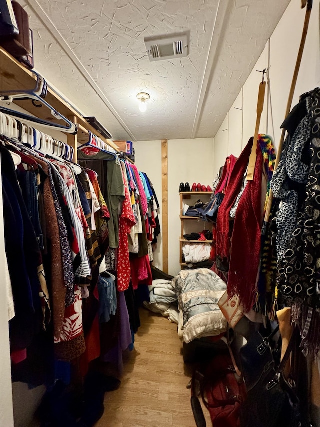 spacious closet with light hardwood / wood-style floors