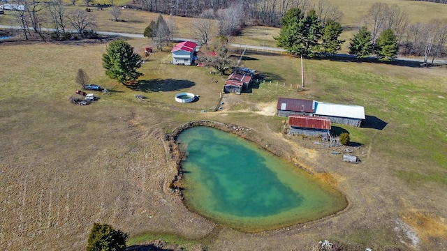 birds eye view of property with a rural view and a water view