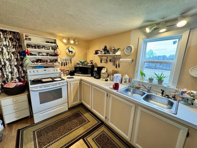 kitchen featuring sink, dark wood-type flooring, white range with electric stovetop, and a textured ceiling