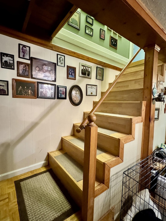 staircase featuring parquet flooring