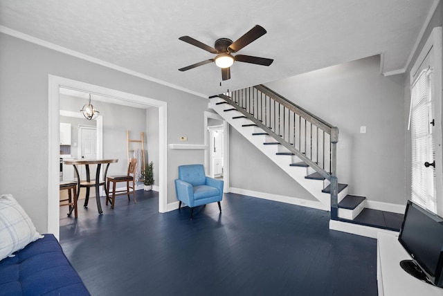 living room featuring ceiling fan, ornamental molding, dark hardwood / wood-style floors, and a textured ceiling