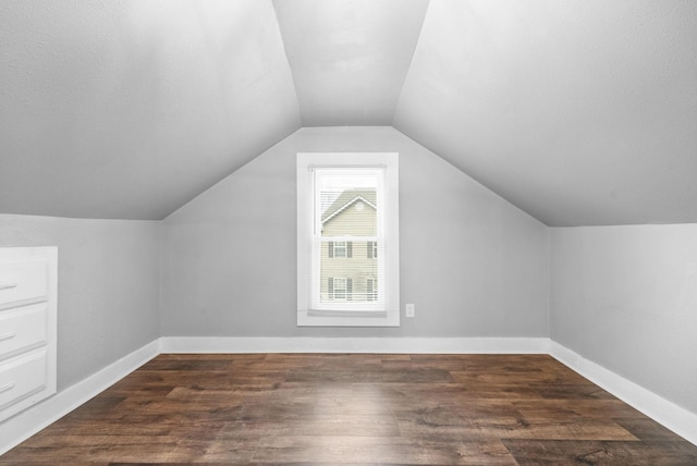 additional living space with lofted ceiling and dark hardwood / wood-style floors