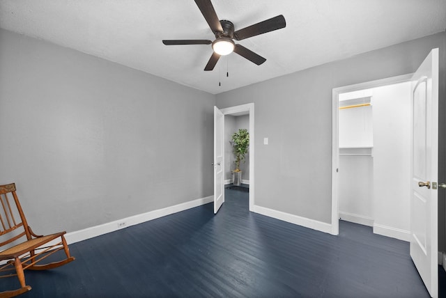 unfurnished bedroom with ceiling fan, dark hardwood / wood-style flooring, and a textured ceiling