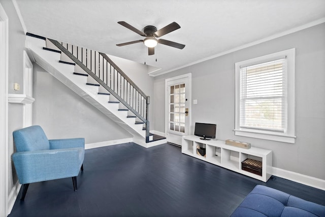 interior space featuring ceiling fan, crown molding, and dark wood-type flooring