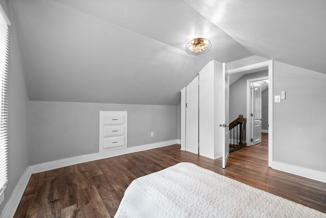 bedroom with lofted ceiling and dark wood-type flooring