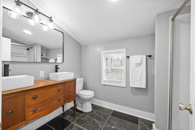 bathroom featuring vaulted ceiling, vanity, toilet, and walk in shower