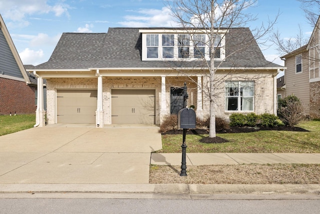 view of front of house with a front yard and a garage