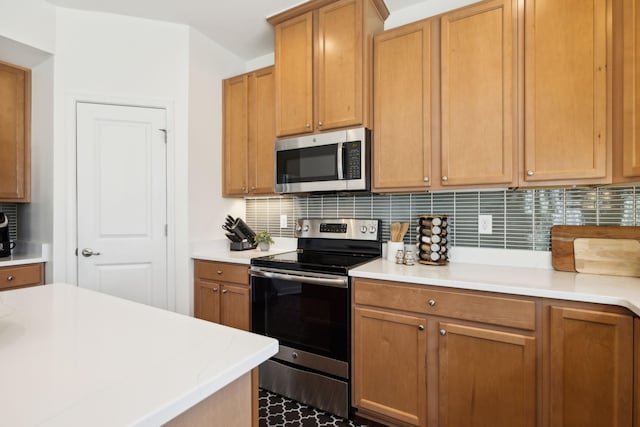 kitchen featuring stainless steel appliances and backsplash