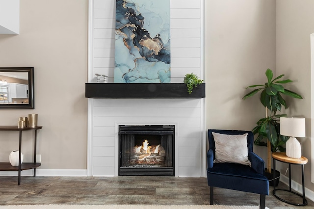 sitting room featuring a fireplace and wood-type flooring