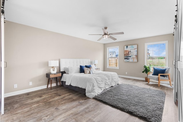 bedroom with ceiling fan and wood-type flooring