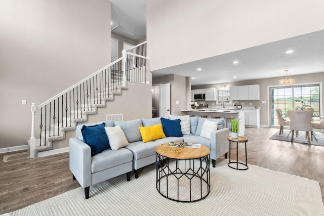 living room with light hardwood / wood-style flooring and a high ceiling