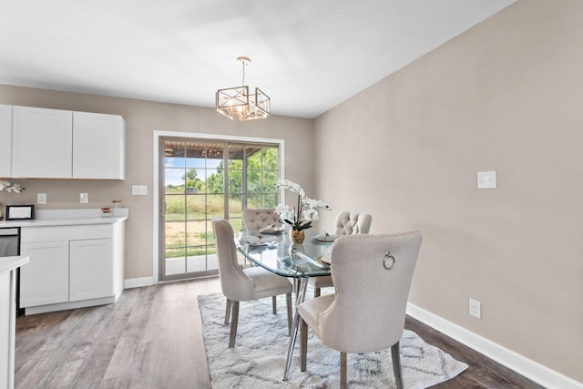 dining space featuring a notable chandelier and light wood-type flooring