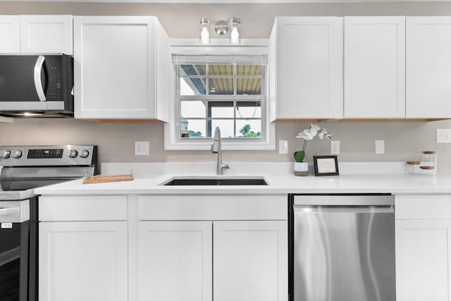 kitchen featuring sink, stainless steel appliances, and white cabinets