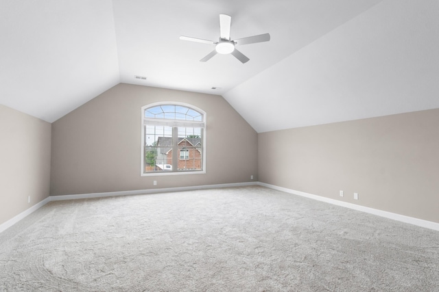 additional living space featuring vaulted ceiling, carpet flooring, and ceiling fan