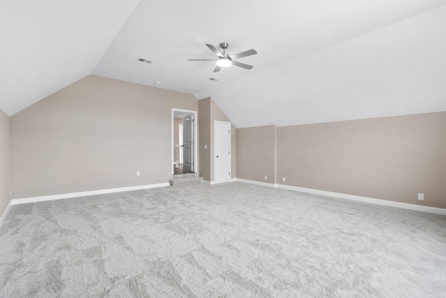 additional living space featuring ceiling fan, light colored carpet, and lofted ceiling