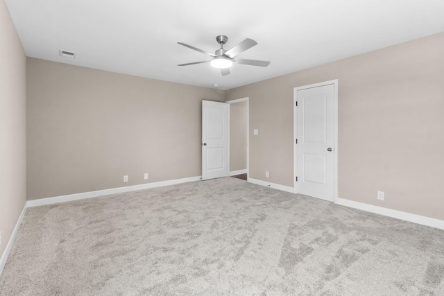 carpeted empty room featuring ceiling fan