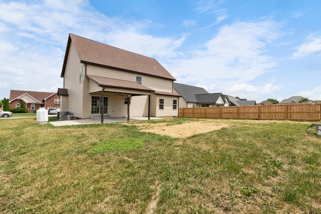 rear view of house with a yard and a patio