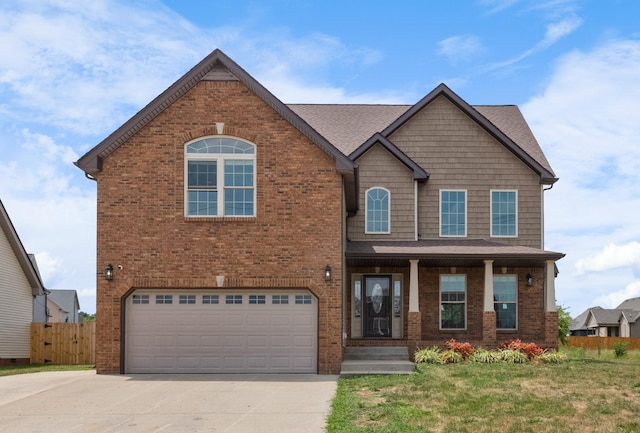 view of front facade with a garage, covered porch, and a front lawn