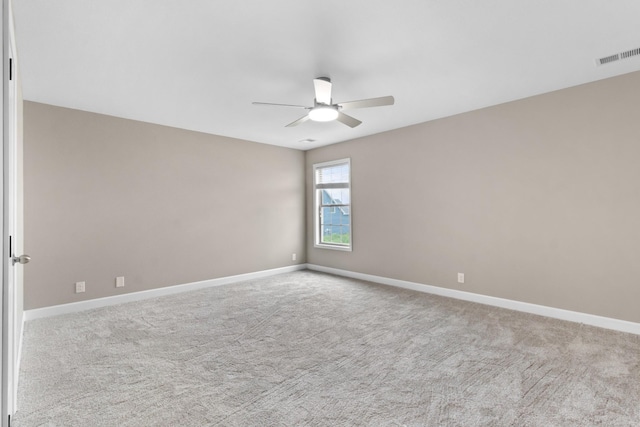 spare room with ceiling fan and light colored carpet