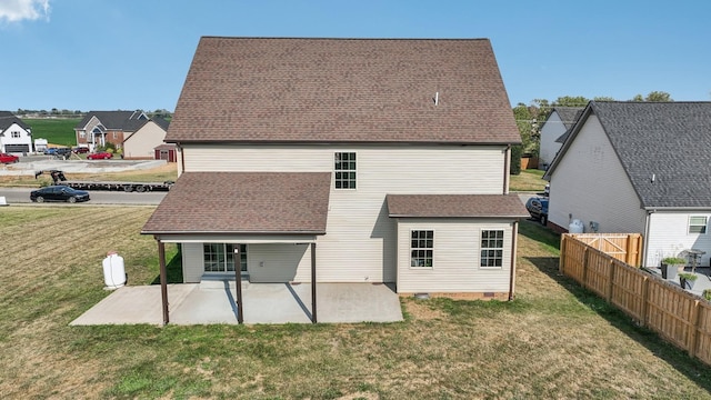 back of house featuring a patio and a yard