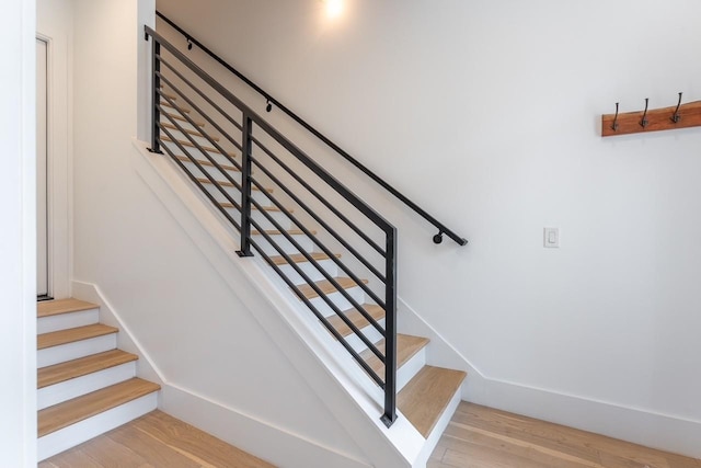 stairway with hardwood / wood-style flooring