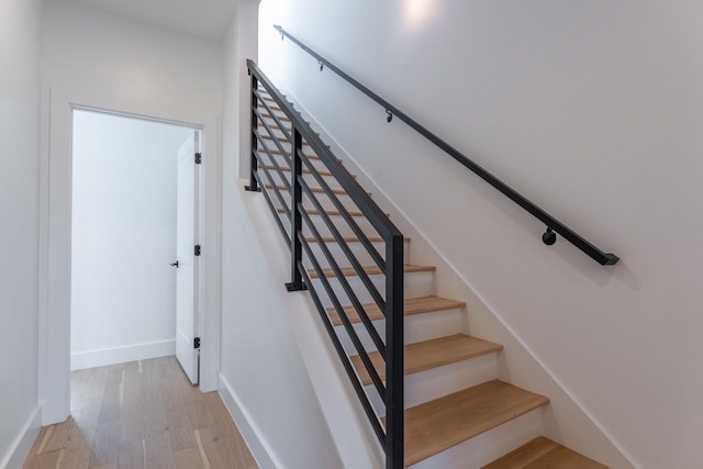 stairs with hardwood / wood-style floors