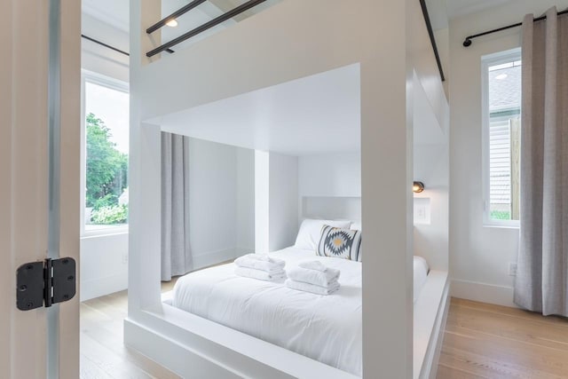 bedroom featuring light wood-type flooring and multiple windows