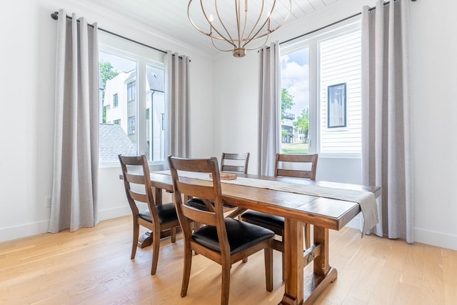 dining area featuring light hardwood / wood-style flooring and a notable chandelier