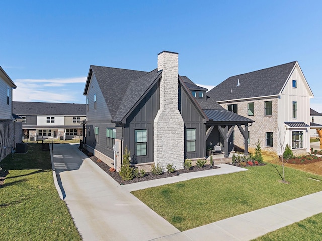 modern inspired farmhouse featuring central AC and a front lawn