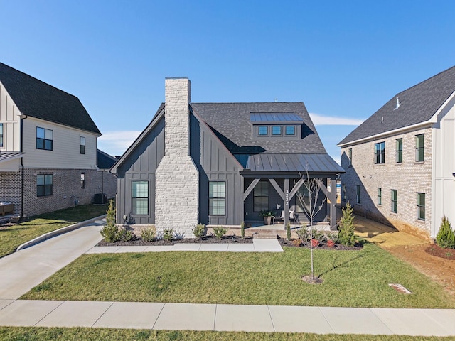 modern farmhouse style home featuring a front yard and a porch