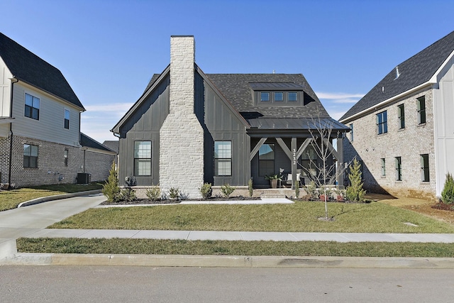 modern inspired farmhouse featuring a front lawn