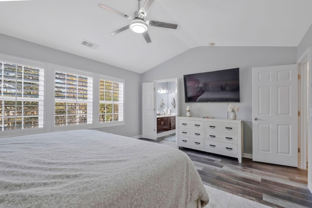 bedroom featuring ensuite bath, ceiling fan, lofted ceiling, and dark hardwood / wood-style flooring