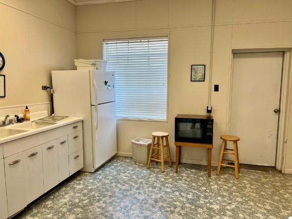 kitchen featuring white cabinetry and white refrigerator