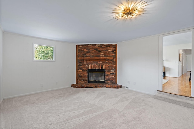 unfurnished living room featuring a fireplace, light carpet, and crown molding