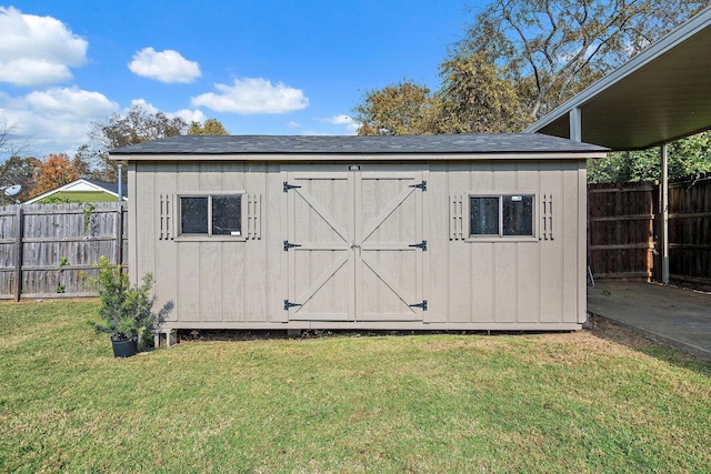 view of outbuilding featuring a lawn