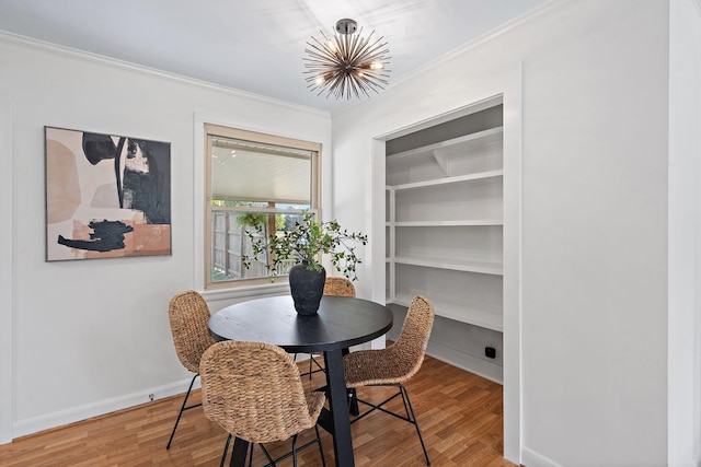 dining space with a chandelier, wood-type flooring, and ornamental molding