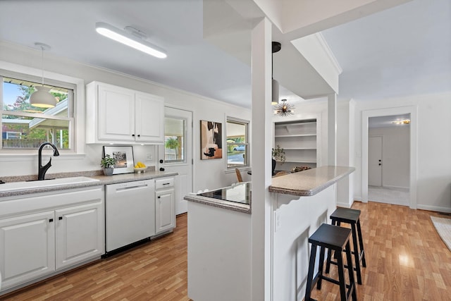 kitchen featuring sink, white dishwasher, and white cabinets