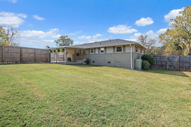 rear view of property featuring a patio and a lawn