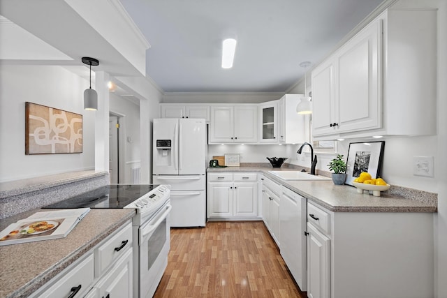 kitchen featuring white appliances, light wood-type flooring, pendant lighting, sink, and white cabinetry