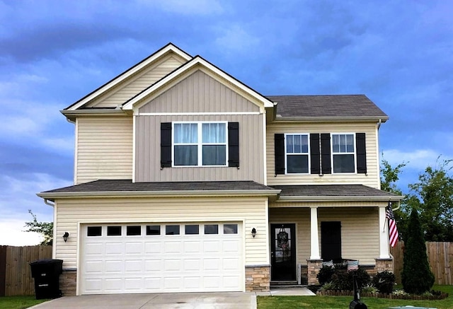 craftsman house with stone siding, driveway, and fence