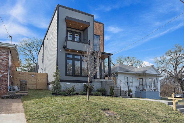 view of front of house with a balcony and a front yard