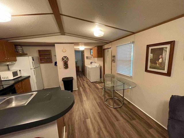 game room with washer and dryer, a textured ceiling, dark hardwood / wood-style flooring, and lofted ceiling with beams