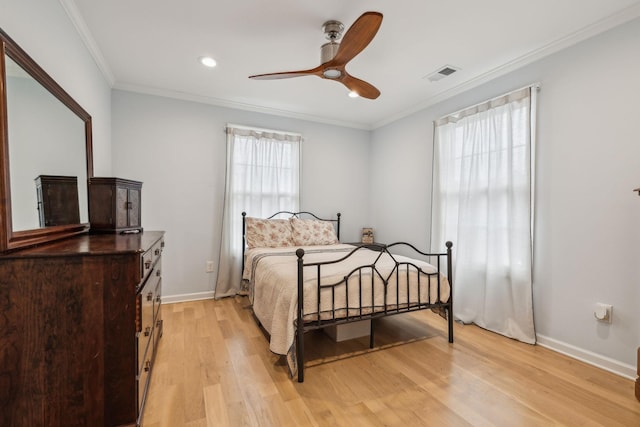 bedroom featuring ornamental molding and light hardwood / wood-style flooring